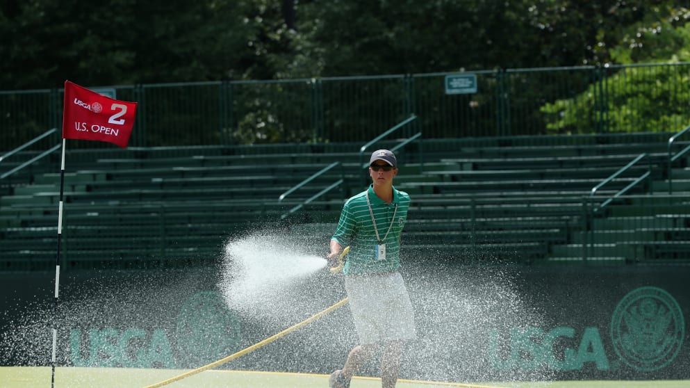 A member of the grounds staff waters a green during a practice round prior to the start of the 114th U.S. Open at Pinehurst Resort & Country Club, Course No. 2 