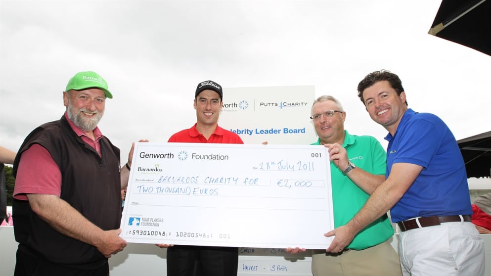 CNN presenter Shane O’Donoghue, Bob Brannock, Genworth Financial President, Europe and Lifestyle Protection, and Genworth's Brand Ambassador Ross Fisher present a cheque to Fergus Finlay, Chief Executive of Barnardos