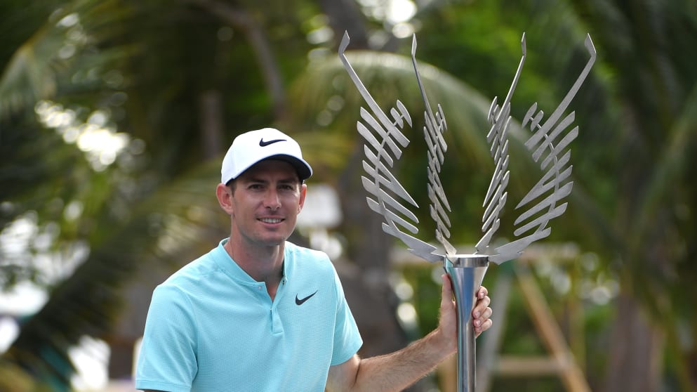 Dylan Frittelli of South Africa holds the trophy as he celebrates victory