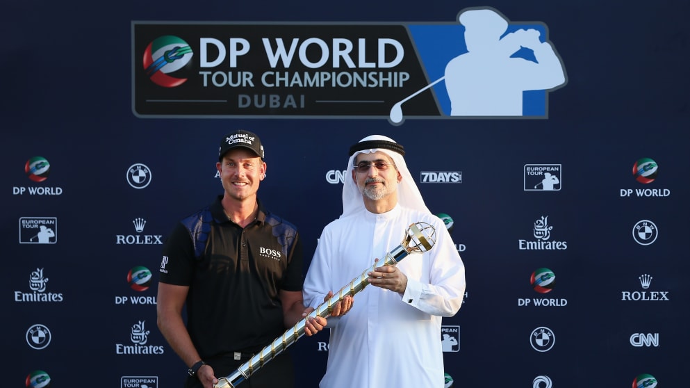 Henrik Stenson is presented with the DP World Tour Championship trophy by Mohammed Sharaf, Group CEO of DP World