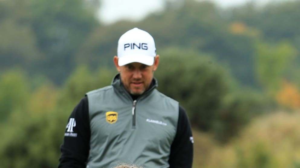 6 year old Caitlin Ellwood putts as Lee Westwood looks on in the Pro-Am