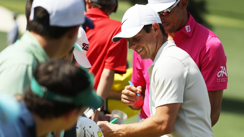 Rory McIlroy signs autographs for patrons at the Masters