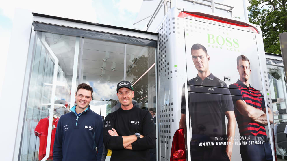 Martin Kaymer and Henrik Stenson pose in front of the Hugo Boss shop