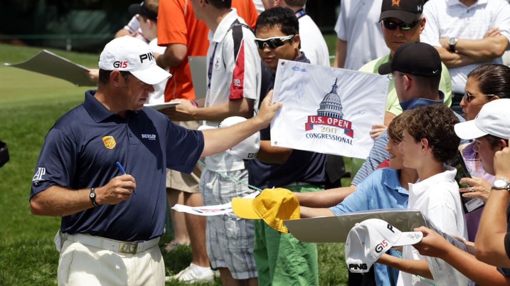 Lee Westwood signs autographs for fans during practice for the US Open