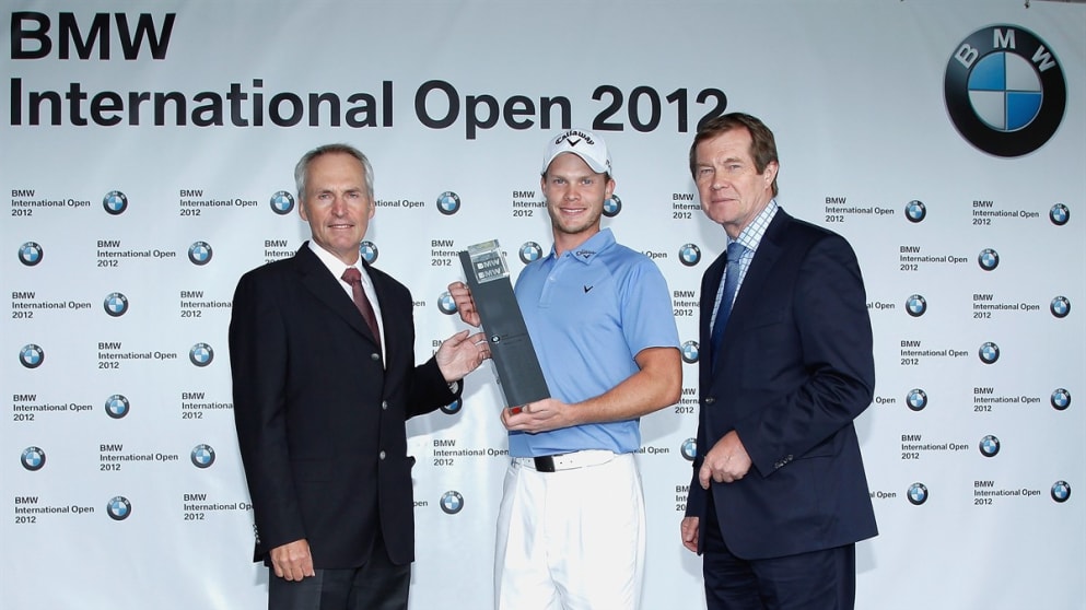 Danny Willett receives the trophy from Doctor Friedrich Eichiner, Member of the board of managment of BMW AG finance & George O'Grady, Chief Executive of the European Tour