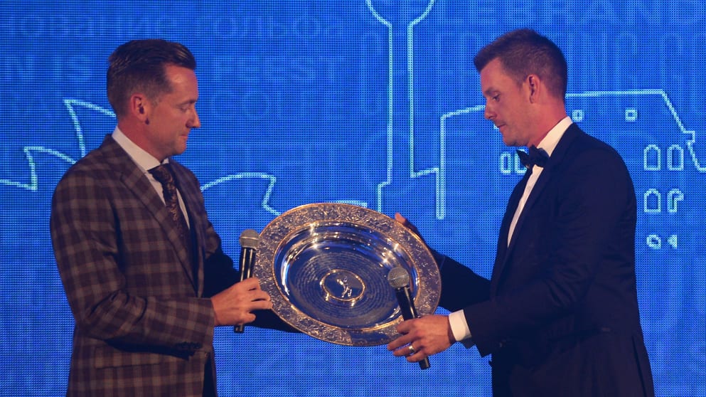 Henrik Stenson (R)  receives the 2013 Players' Player of the Year award from Ian Poulter during the European Tour Players' Awards ahead of the BMW PGA Championship
