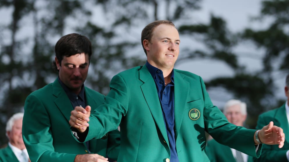 Bubba Watson presents Jordan Spieth with the green jacket after Spieth won the 2015 Masters Tournament 