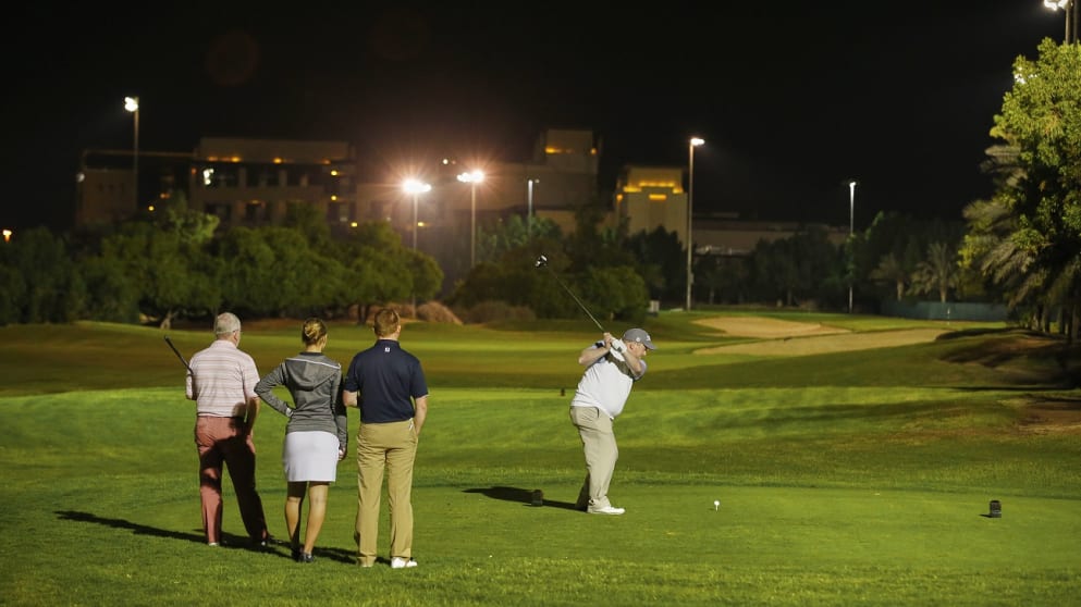 MyET member Neil McKinnon tees off under the Abu Dhabi GC floodlights