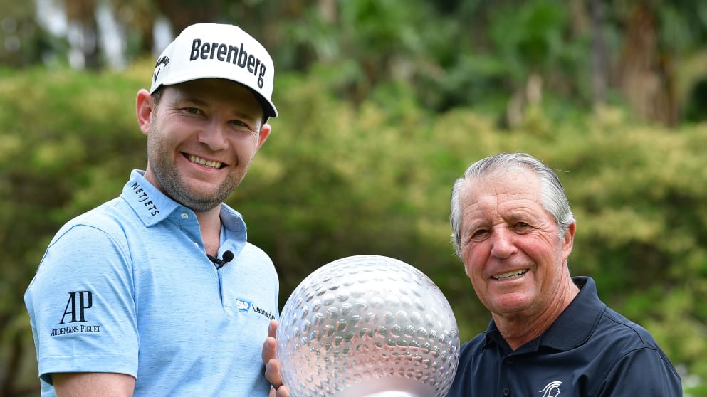 Defending champion Branden Grace hands back the trophy to tournament host Gary Player