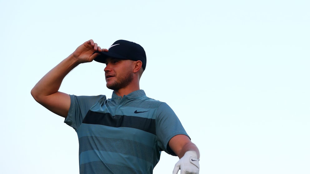 Oliver Fisher looks on at the driving range 