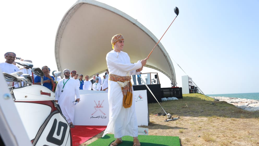 His Highness Sayyid Kamil bin Fahad Al Said hits a ceremonial tee shot into the Gulf of Oman to officially launch the 2014 National Bank of Oman Golf Classic