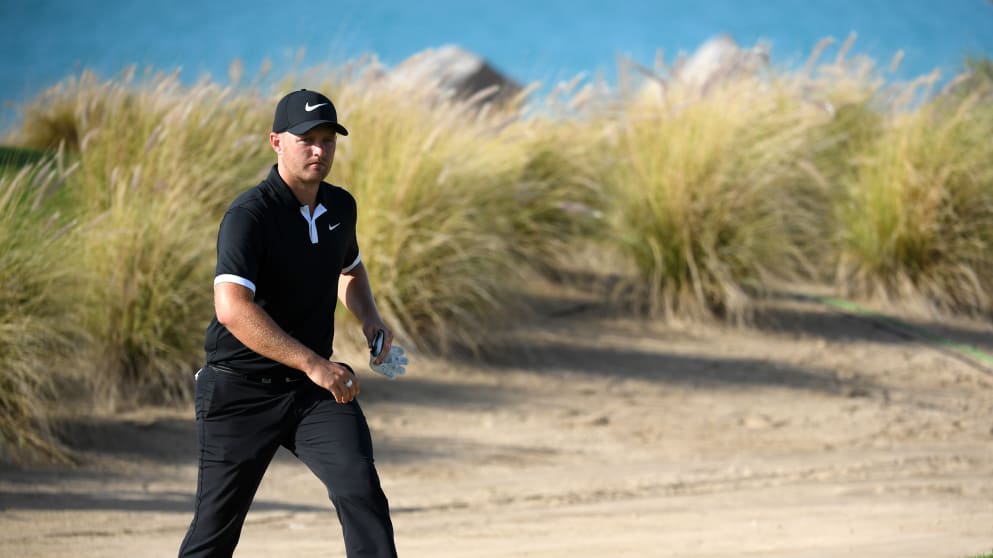 Tom Lewis of England walks off on the 16th hole 