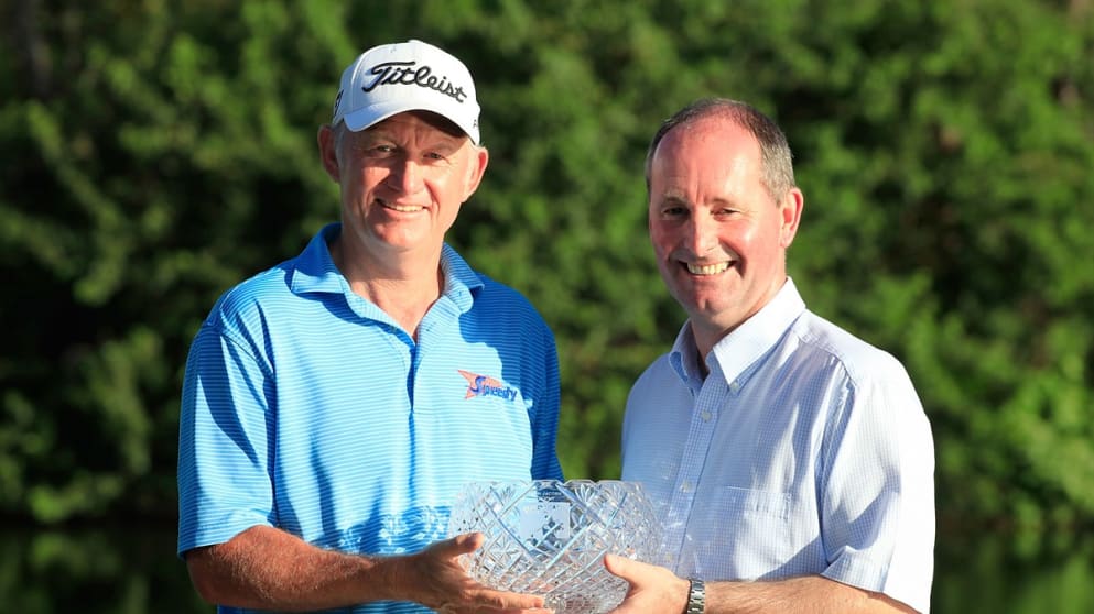 Roger Chapman receives the John Jacobs Trophy from  Andy Stubbs, MD of the Senior Tour,