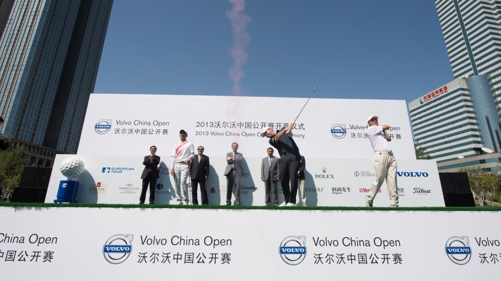 Branden Grace of South Africa drives a smoking ball over the Hai River during the opening ceremony of the Volvo China Open at Tianjin, China (Richard Castka/Sportpixgolf.com)