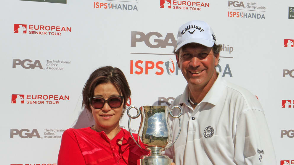 Santiago Luna of Spain is presented with the trophy by Midori Mizaki Executive Director of International Affairs to Dr Handa after the final round of the ISPS Handa PGA Seniors Championship played at Stoke by Nayland Hotel 