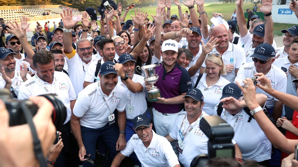 Tyrrell Hatton - poses for the cameras with the Italian Open trophy and the stewards 