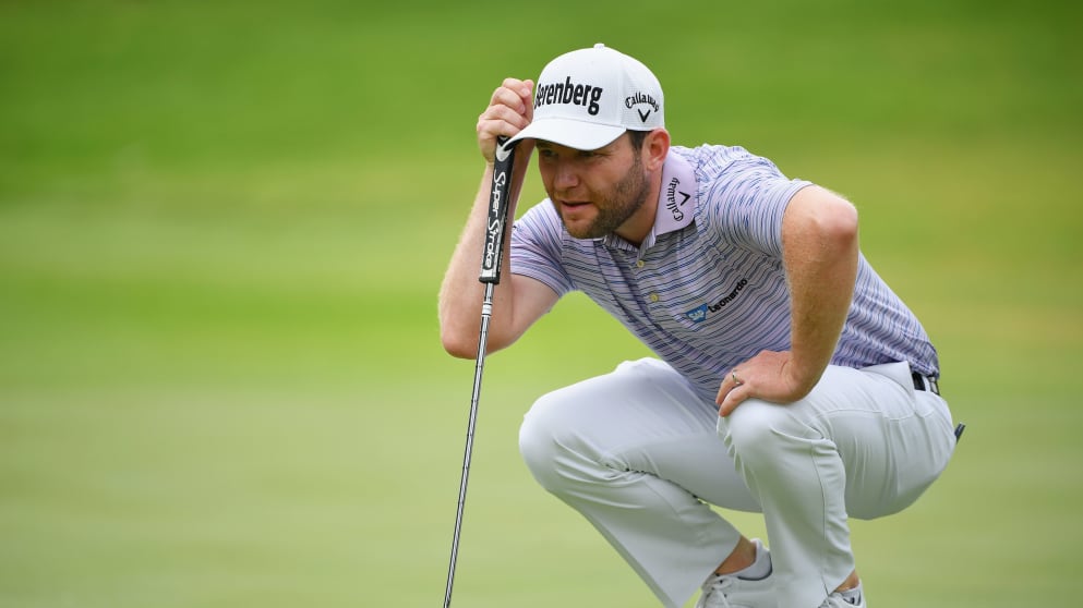 Branden Grace of South Africa lines up a putt during the final round
