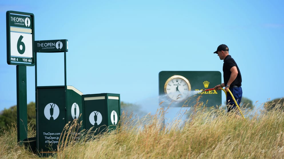 A groundskeeper waters the course ahead of The 142nd Open Championship at Muirfield