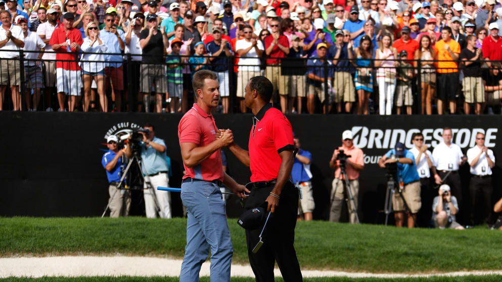 Tiger Woods (L) shakes hands with Henrik Stenson 
