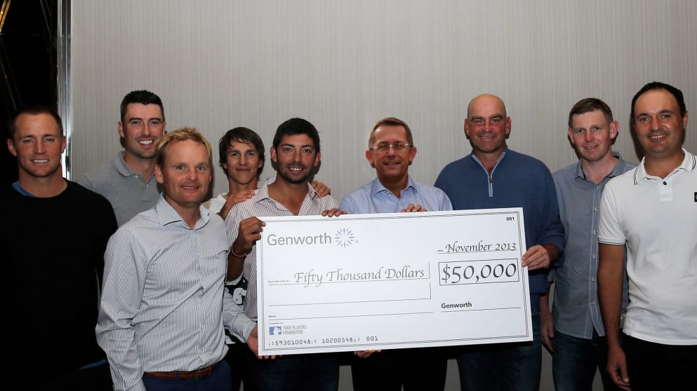 Players pose with a donation to the Tour Players Foundation from Genworth