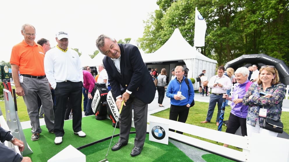 Tony Jacklin putts watched by David Clinton (L), Chairman of the Challengers charity and Thomas Levet of France during the launch of the Mega Putt Challenge