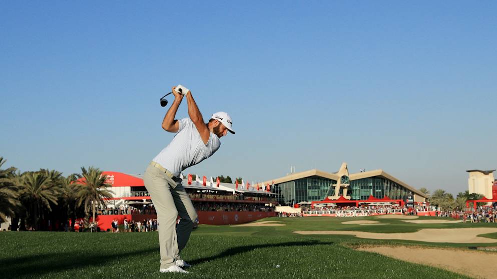Dustin Johnson - hits his approach to the 18th hole during round two of the Abu Dhabi HSBC Golf Championship