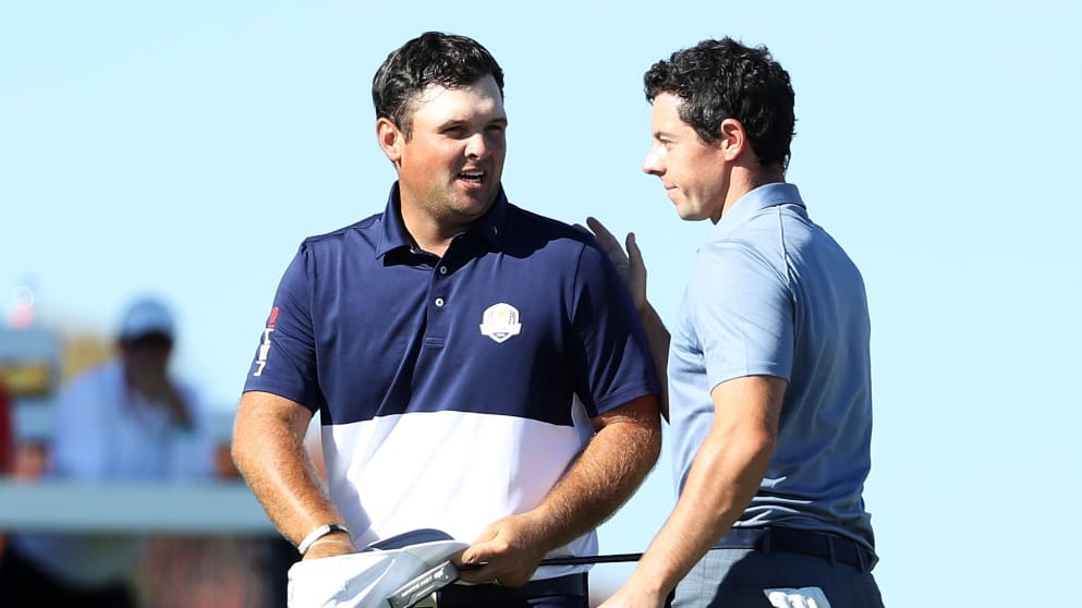 Patrick Reed shakes hands with Rory McIlroy in the top match