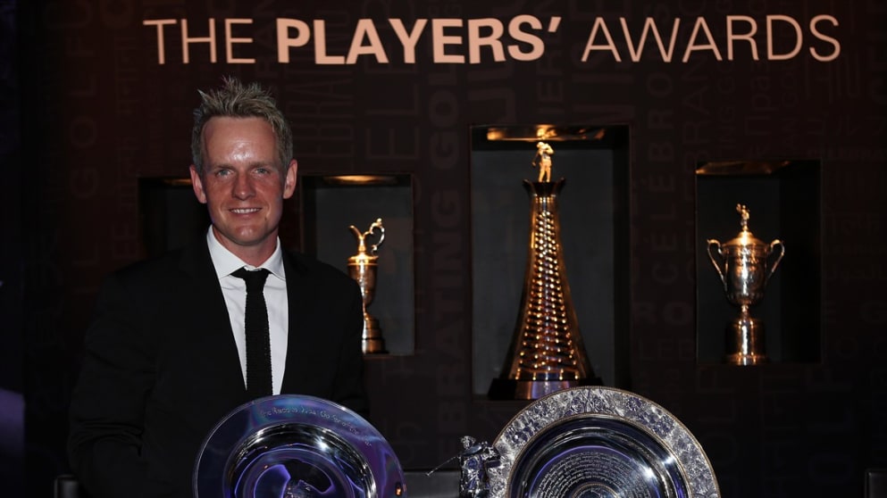 Luke Donald poses with the Golfer of the Year trophy, the Vardon Trophy and the Players' Player of the Year award