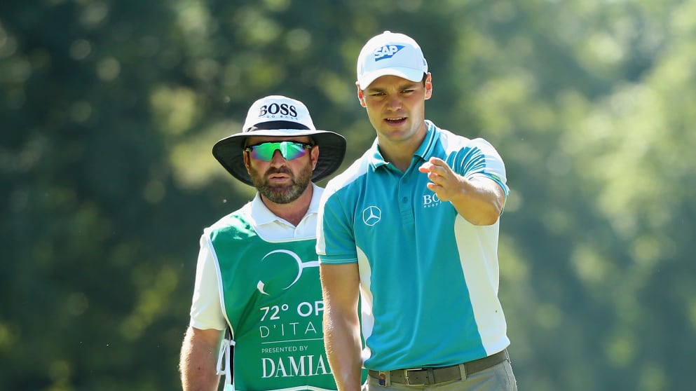 Martin Kaymer  and his caddie Craig Connelly line up a putt on the second 
