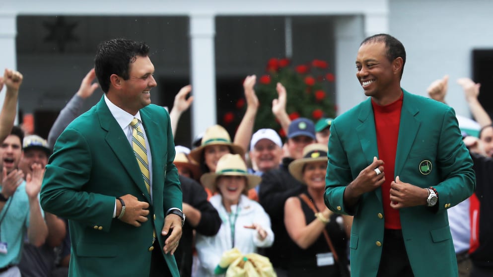 Tiger Woods being awarded the Green Jacket by reigning Masters champion Patrick Reed (L) 