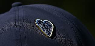 Commemorative pin designed as tributes made to Crans-Montana fire tragedy victims