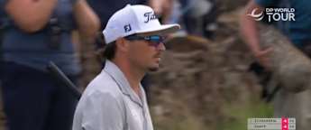 Ewen Ferguson chips over the wall to save par at the 12th