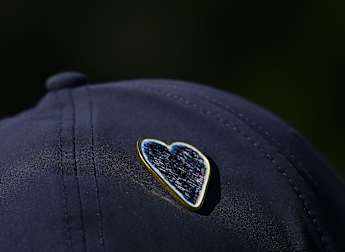 Commemorative pin designed as tributes made to Crans-Montana fire tragedy victims