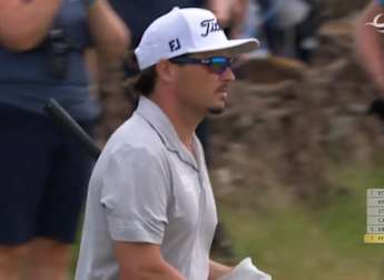 Ewen Ferguson chips over the wall to save par at the 12th