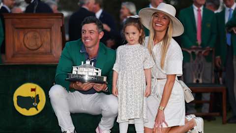 New Green Jacket winner McIlroy celebrates with his daughter, Poppy, and wife, Erica at Augusta National