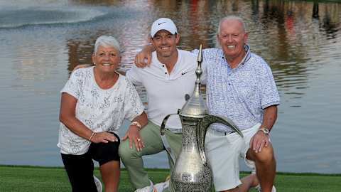 McIlroy celebrates his fourth Hero Dubai Desert Classic title in 2024, recreating an image with his parents after his first 15 years earlier