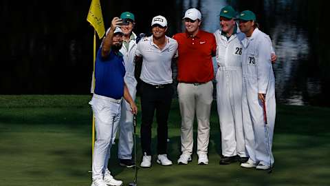 Tyrrell Hatton takes a selfie with Viktor Hovland, Robert MacIntyre and their caddies