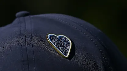 image: Commemorative pin designed as tributes made to Crans-Montana fire tragedy victims